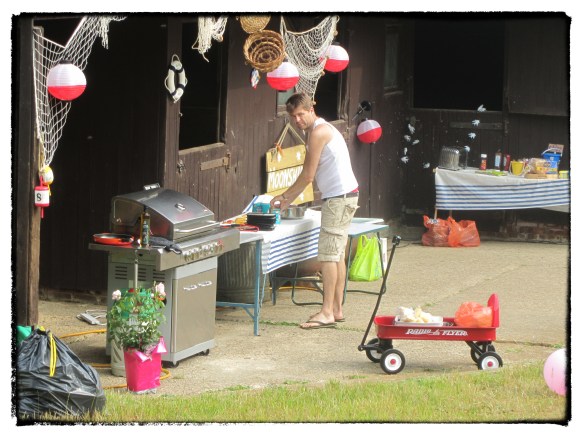 Stu serving breakfast from the BBQ for the campers